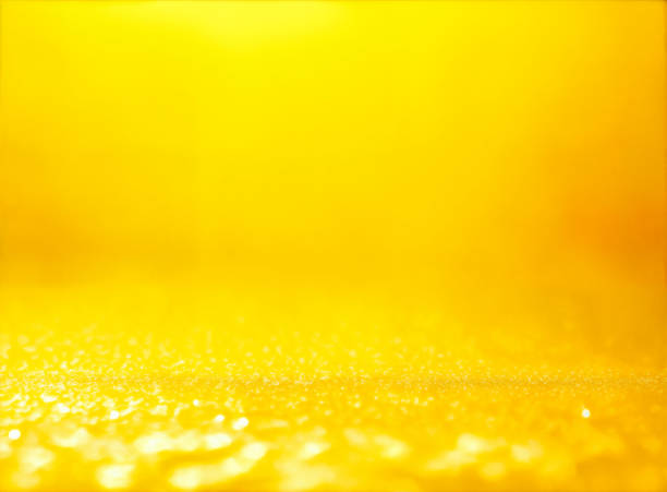 yellow abstract background with bokeh defocused lights stock photo