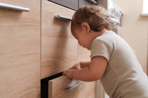istock Little child exploring drawer indoors. Dangerous situation 1480658773