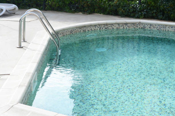 istock Ladder with grab bars in outdoor swimming pool 1480659384