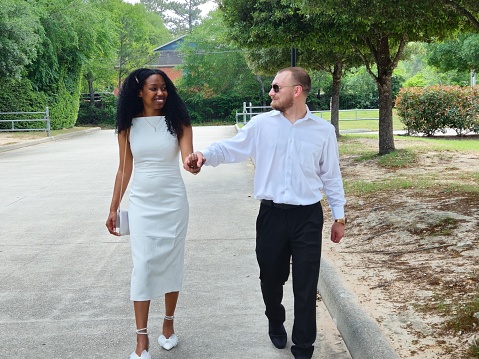 Young Adult Interracial Couple Holding Hands While Walking