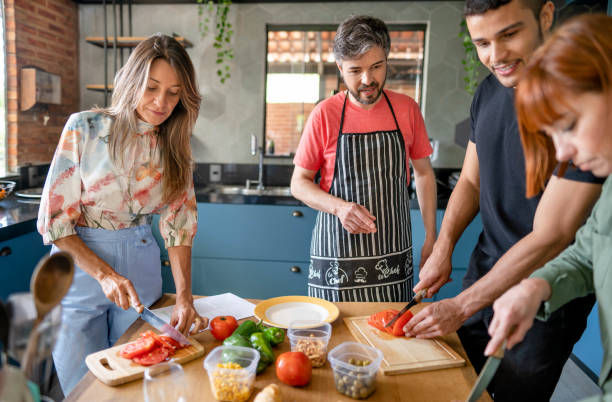 istock Instructor watching adult students chop vegetables during a cooking class 1480663506