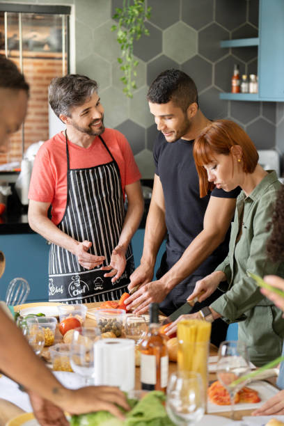 istock Smiling teacher talking with adult students during a cooking class 1480663539