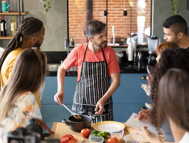 istock Teacher showing adult students cooking techniques during a class 1480663548