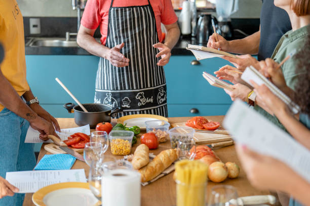 istock Teacher explaining cooking techniques to adult students during a class 1480663553
