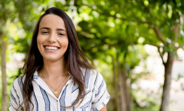istock Laughing young woman standing in a park in summer 1480667708