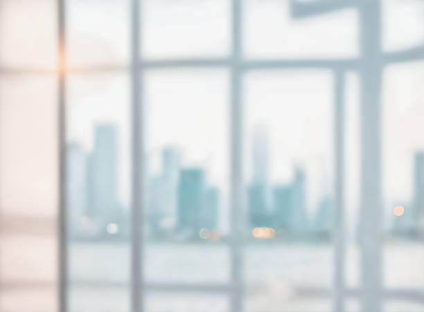 Blurred abstract glass wall from building in city town background.