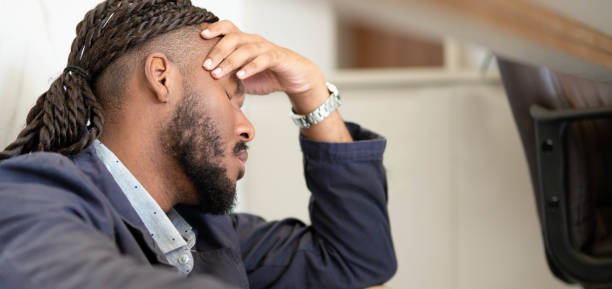 istock Young businessman sitting on an office floor during a stressful at work 1480671174