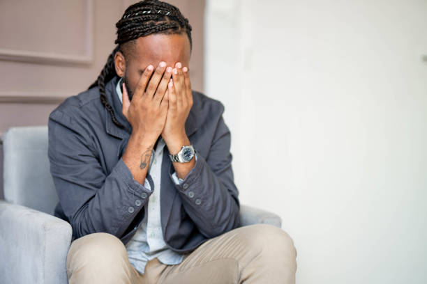 istock Stressed young businessman sitting at work with his head in his hands 1480671175