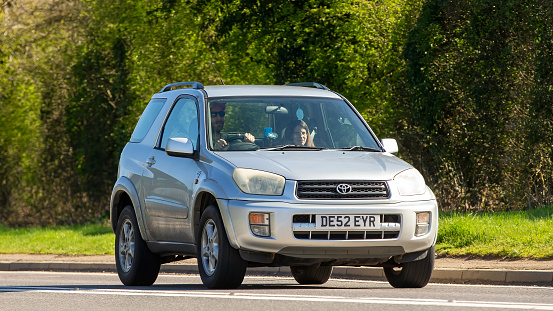 Bicester,Oxon, UK - April 7th 2023. 2002 silver Toyota Rav 4 car travelling on an English country road