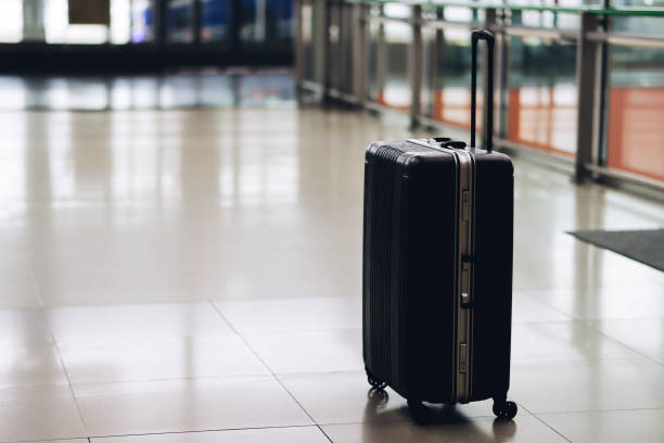 istock Airport lobby and black carry case 1480680645