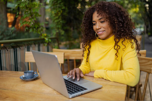 istock Beautiful Brazilian young woman outdoors using laptop 1480681331