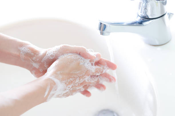 istock woman washing hands with soap 1480682084