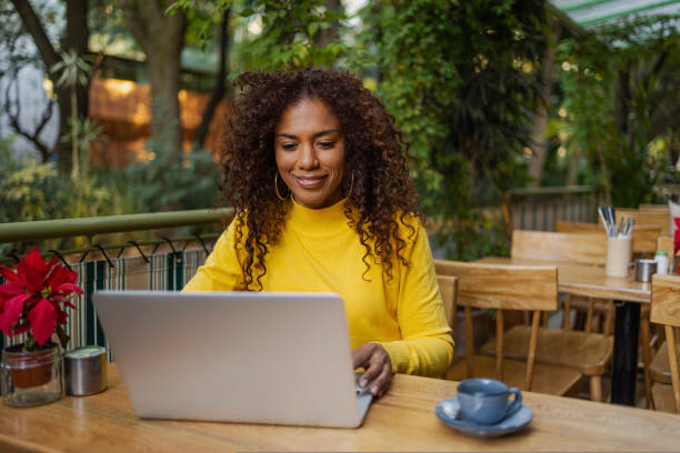 istock Beautiful Brazilian young woman outdoors using laptop 1480682419