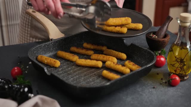 Mozzarella Cheese sticks are fried in oiled grill frying pan