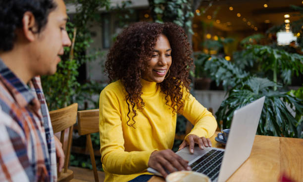 istock Attractive young multiethnic couple outdoors using laptop 1480690368