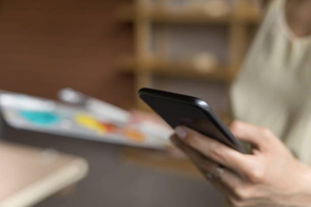 istock Young Caucasian woman holding cellphone, typing online chat message 1480690697