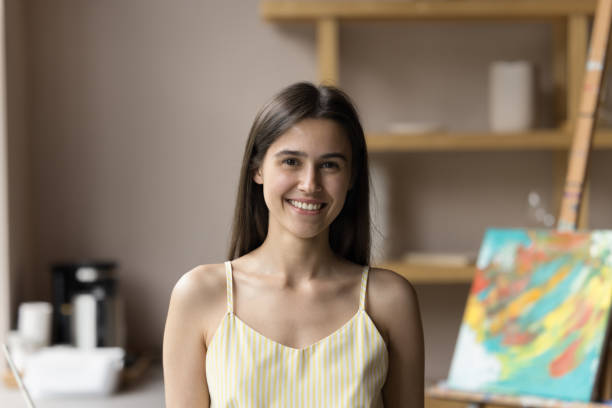 istock Cheerful pretty young art school student posing in creative space 1480690706