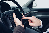 istock Man using mobile phone in the car 1480691506
