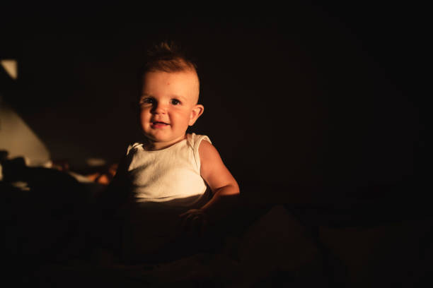 Portrait of a cute little baby boy in the shadow