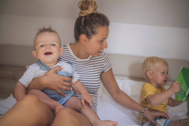 The woman takes care of her two little sons