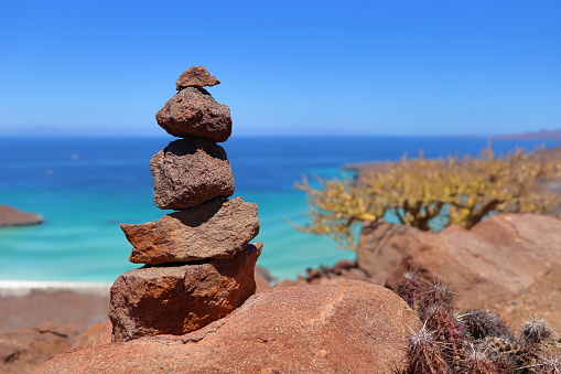 A mound of stones to delineate the path with the sea of Cortes in Mexico in the background