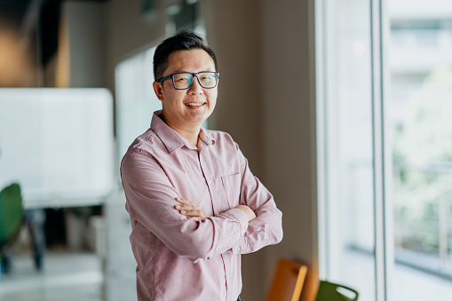 Portrait of a smiling and confidence Asian Chinese businessman in office