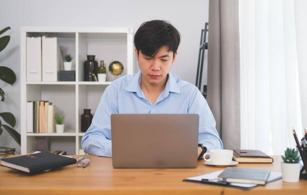 istock Asian man freelancer working online with computer tablet at home. 1480703807