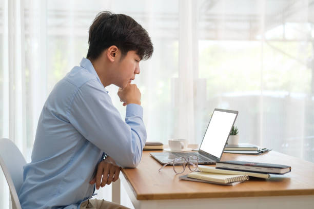 istock Gorgeous young businessman sitting in bright office and looking at computer laptop screen. 1480703813