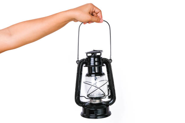 A kerosene lamp on a white background with lit fuse