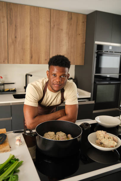 istock Young black man preparing fried chicken mince with vegetables recipe. 1480706284