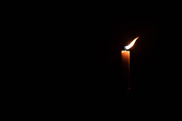 istock Illuminated candle seen in dark room 1480713428