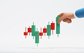 Candlestick chart in hands of businessman on white background.