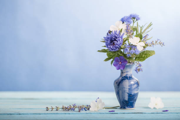 istock summer flowers in blue vase on blue background 1480714960