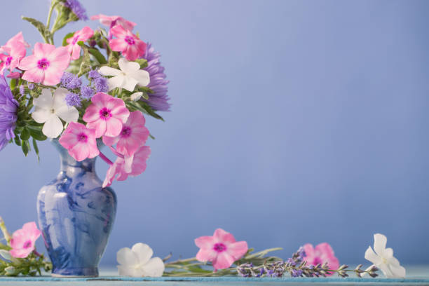 istock summer flowers in vase on blue background 1480714962