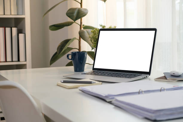 istock Laptop computer with blank screen, accountant documents, coffee cup and office supplies on white table. 1480715853