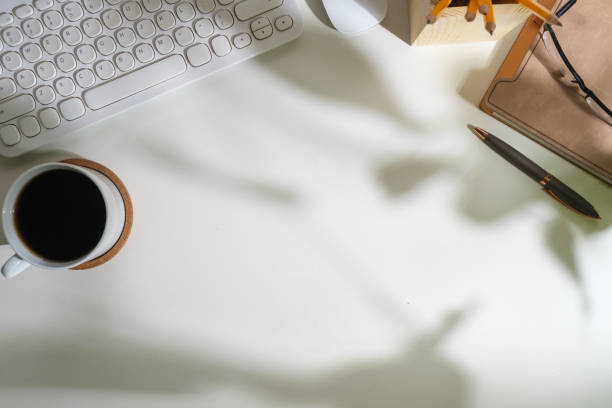 istock White office desk with diary, keyboard, coffee cup and glasses. Top view with copy space for your text. 1480716087