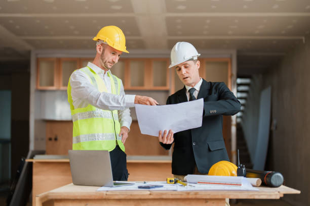 istock multi ethnic engineer brainstorming and measuring for cost estimating on blueprint and floor plan drawings about design architectural and engineering for houses and buildings 1480720102