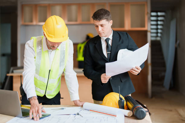 istock multi ethnic engineer brainstorming and measuring for cost estimating on blueprint and floor plan drawings about design architectural and engineering for houses and buildings 1480720198