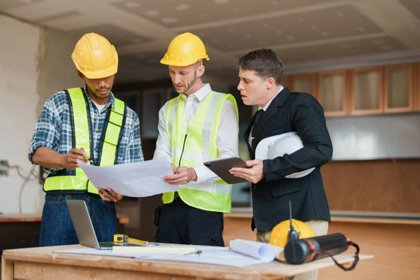 istock multi ethnic engineer brainstorming and measuring for cost estimating on paperworks and floor plan drawings about design architectural and engineering for houses and buildings 1480720325