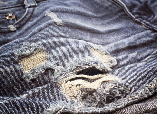istock blue faded ripped jeans closeup 1480725852