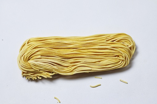dry pasta noodles on a white background
