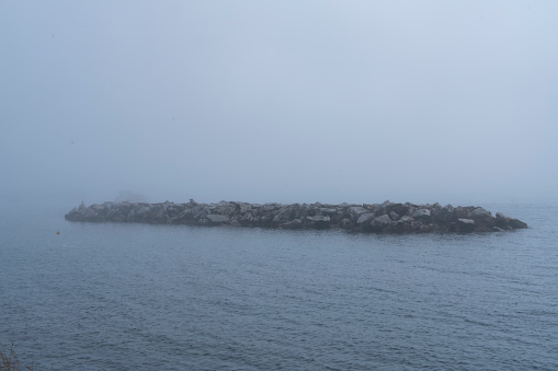 Serene Photo of a winter harbor and smooth as glass water with a gas / petrol refilling station