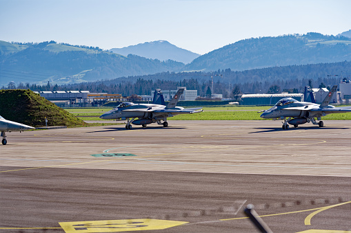 Two Boeing FA-18 Hornet preparing for take off at Swiss Air Force airbase Emmen, Canton Luzern, on a sunny spring day. Photo taken March 22nd, 2023, Emmen, Switzerland.