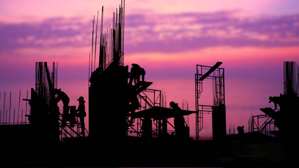 istock silhouette worker work late in construction site against beauty sky  nature background 1480727979