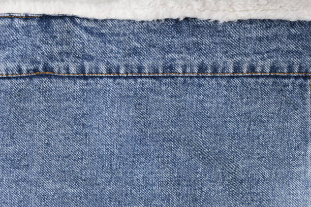 Blue jeans background and texture close up.Denim seam.