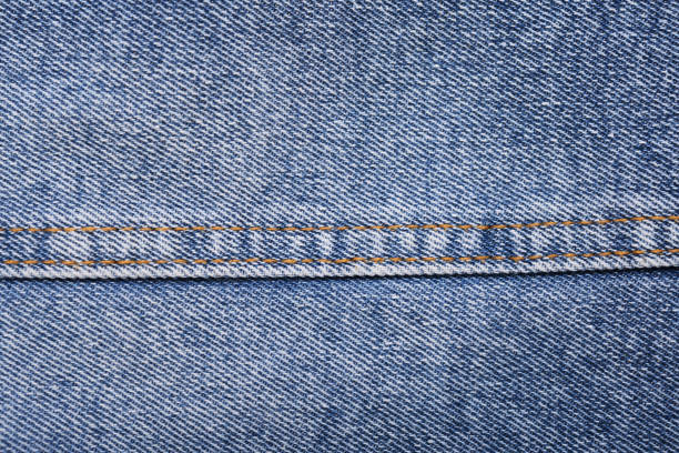 Blue jeans background and texture close up.Denim seam.