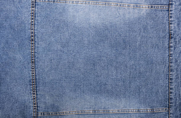 Blue jeans background and texture close up.Denim seam.