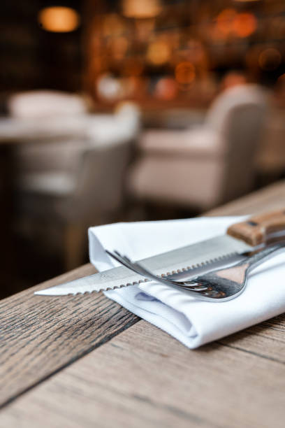 istock Cutlery fork and knife on a white napkin in a restaurant 1480729667