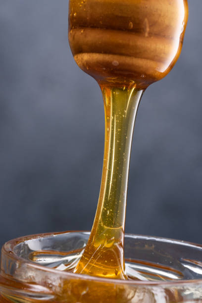 istock Jar of honey and honey spoon 1480729680