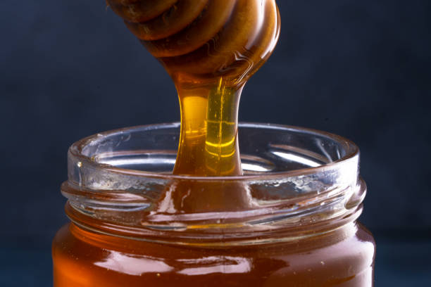 istock Jar of honey and honey spoon 1480729708